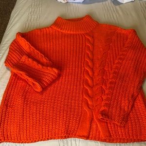 Bright orange, oversized turtle neck sweater